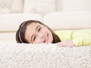 girl lying on floor of carpet
